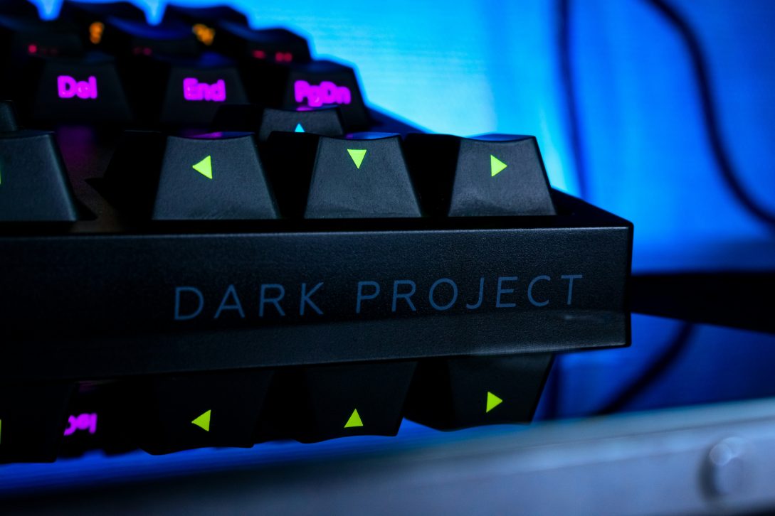Dark keyboard with neon blue lights representing AI-powered WordPress development